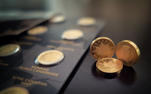 Load image into Gallery viewer, Close-up of three 99.99% pure gold Canadian MapleGram coins next to a Royal Canadian Mint MapleGram sheet.