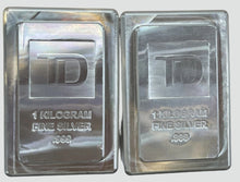 Load image into Gallery viewer, Two 1-kilogram fine silver bars with TD logo on a white background
